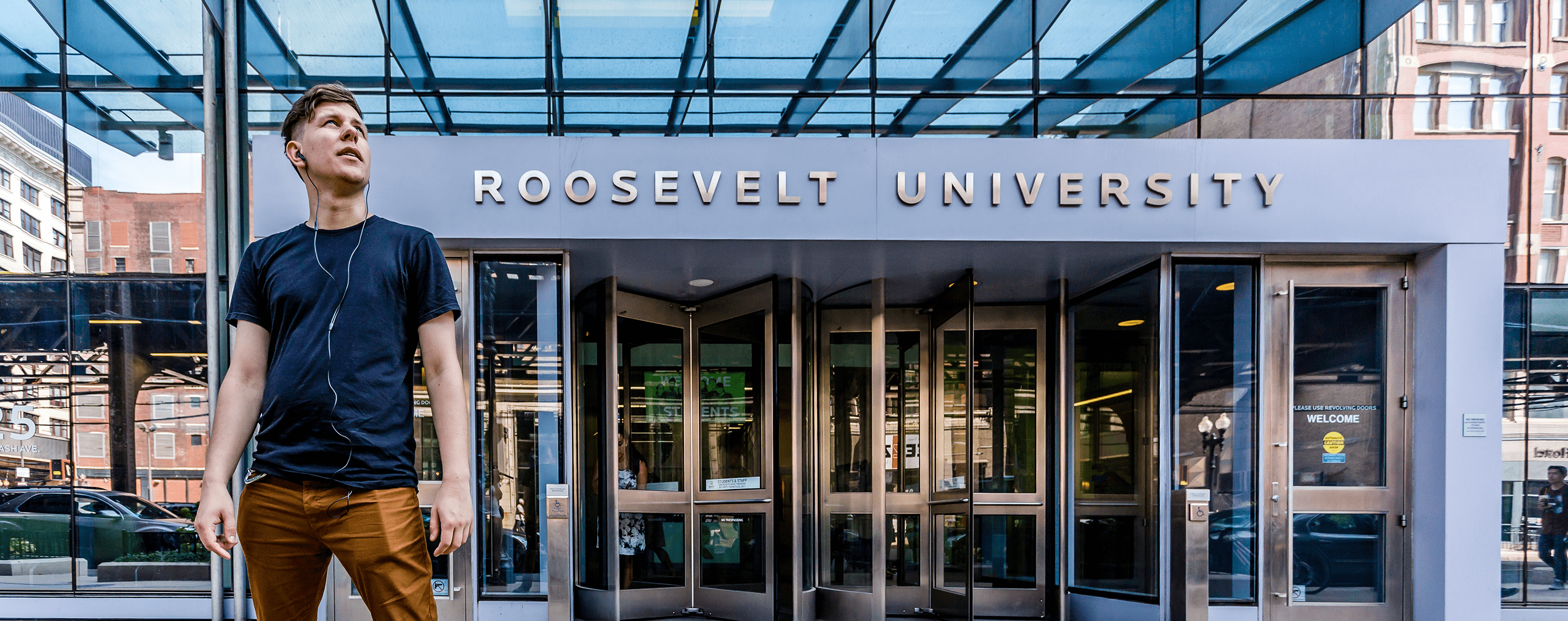 Entrance of Roosevelt University with revolving glass doors.
